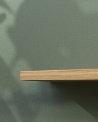 3d Empty Wooden shelf for your bio, eco, green product presentation with shadow on sage green wall. Minimal 3d rendering