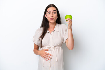 Young caucasian woman isolated on white background pregnant and holding an apple