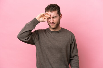 Young caucasian man isolated on pink background with tired and sick expression