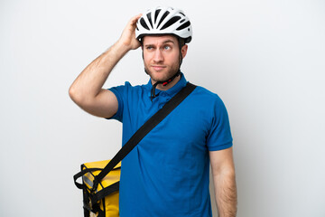 Young caucasian man with thermal backpack isolated on white background having doubts and with confuse face expression