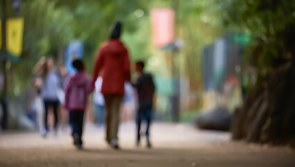 A background image featuring indistinct figures of an adult and two children enjoying an outdoor walk. Ideal for showcasing family leisure, nature, and a relaxed atmosphere