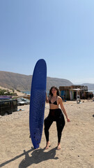 Young woman enjoying surf trip in morocco