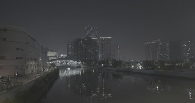 Night Payoff with Riverside Pathway and Vibrant Cityscape Reflections