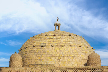 Dome from baked brick of Samanid Mausoleum against blue sky background in Bukhara, Uzbekistan. Built in the 10th century CE