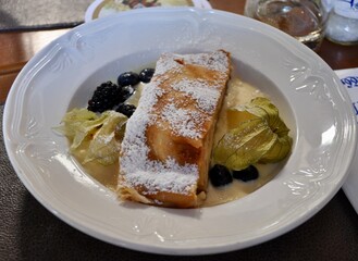 Traditional German apple strudel dessert. Close-Up Of Apple Strudel And Ice Cream Served In Plate. Typical Bavarian dessert apple strudel with vanilla cream