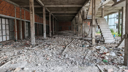 Ground level view of building under construction with partial red brick layout
