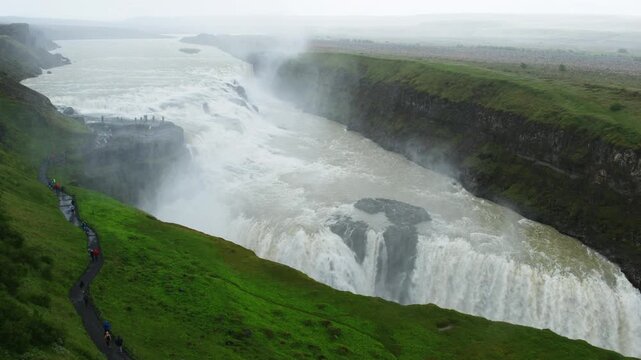 Iceland. A view of a big waterfall in Iceland during a cloudy summer day. Touristic destination