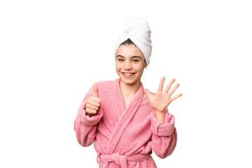 Little girl in a bathrobe over isolated chroma key background counting six with fingers