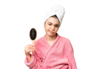 Young girl with hair comb with sad expression