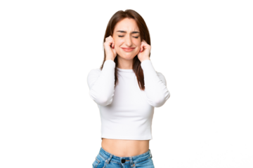 Young caucasian woman over isolated chroma key background frustrated and covering ears