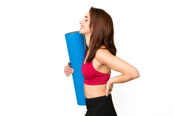 Young sport caucasian woman going to yoga classes while holding a mat over isolated chroma key background suffering from backache for having made an effort