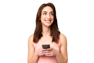 Young caucasian woman over isolated chroma key background using mobile phone and looking up