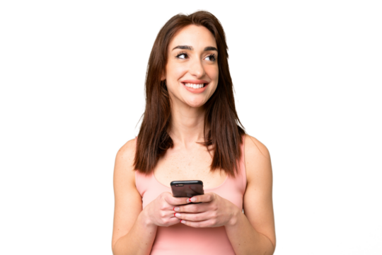 Young caucasian woman over isolated chroma key background using mobile phone and looking up