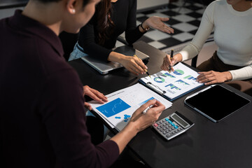 Business team working and studying together with tablet document graph paper in office, discuss finance and marketing solution reporting file in working place.