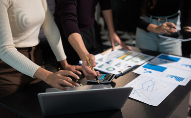 Businessmen team or financial data analysts working with tablets and laptop computers and data graphs together.