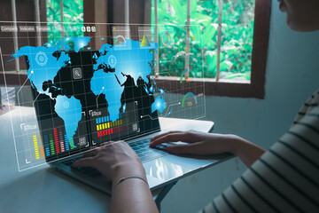 Global business and supply chain management. A businesswoman uses a laptop with a futuristic dashboard to analyze the world map, tracking logistics, and international market data for investment.