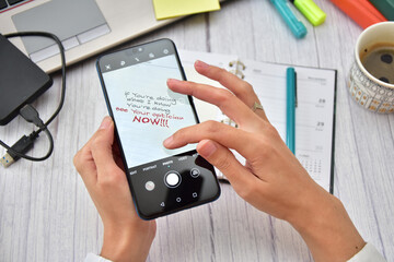 Woman zooming in small text on her phone screen due to bad eyesight