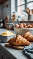 Freshly baked croissants and scrambled eggs in a cozy kitchen setting during morning preparation