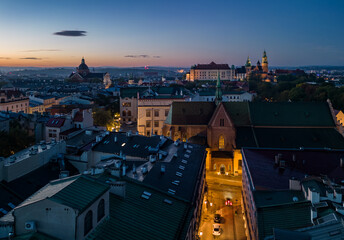 Aerial view of Krakow old town in the night with St Francis church and Wawel Castle above the houses' roofs