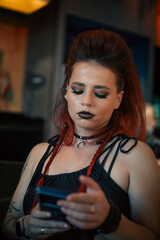 A punk girl with a beautiful mohawk. Red hair. A girl in a black dress at a party.