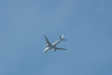 Airplane flying in clear blue sky