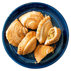 Golden fried pastries filled with savory ingredients on a dark blue plate. 