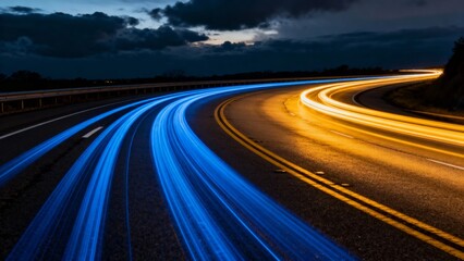 A dynamic long-exposure view of a highway at dusk, showcasing vibrant blue and yellow light trails from moving vehicles against a dark sky with scattered clouds.