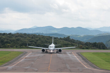 Airliner moving along airport taxiway