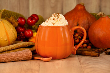 Orange coffee mug with whipped cream on wooden background stock photo images. Autumn cozy background with sweet creamy latte coffee drink and pumpkins stock photo. Pumpkin spice latte still life photo
