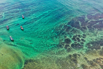 Sri Lanka travel image—Weligama Beach with traditional fishing vessels, ocean waves, and lush palm trees.
