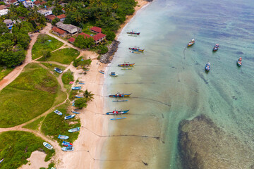 Weligama Beach drone photography—Sri Lankan fishing boats, palm-lined coast, and scenic Indian Ocean shoreline