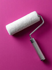 Obraz premium Paint roller on a pink background, minimalistic style.