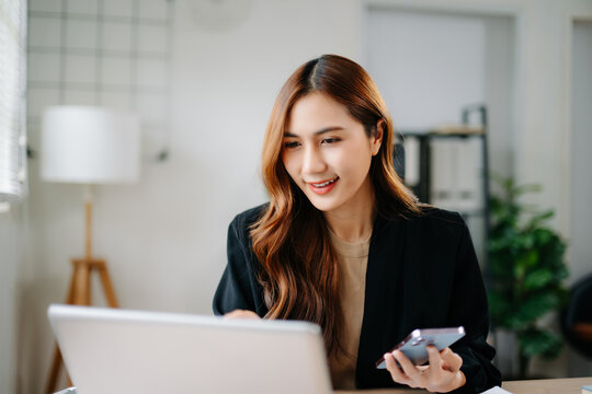 Business woman using tablet and laptop for doing math finance on an office desk, tax, report, accounting, statistics, and analytical research concept in office