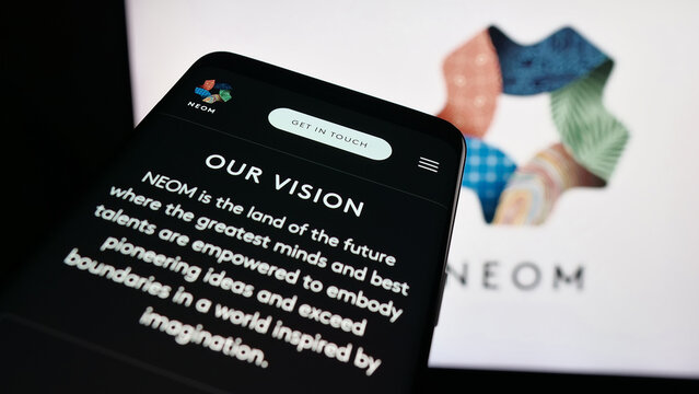 Stuttgart, Germany - 09-29-2025: Mobile phone with website of Saudi Arabian real estate project NEOM on screen in front of logo. Focus on top-left of phone display.