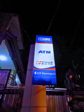 Denpasar, Indonesia - August 20, 2025: A BRI (Bank Rakyat Indonesia) ATM sign for the KCP Diponegoro branch, showing accepted cards like Visa and the BRIZZI e-money logo.