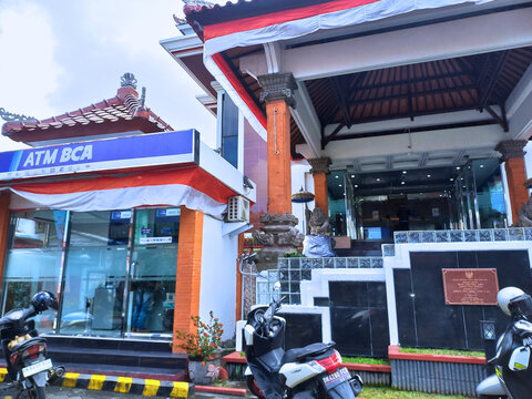 Denpasar, Indonesia - August 20, 2025: The entrance to a BCA (Bank Central Asia) branch in Bali, featuring a blend of modern design and traditional Balinese architecture.