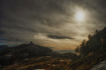 Autumn land scape with clouds over the mountains