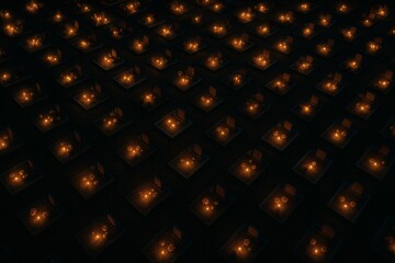 Obraz premium Cemetery at Night with Rows of Candle Lit Graves, Overhead Drone View Showing Symmetrical Arrangement and Warm Orange Yellow Candlelight in a Rural Landscape