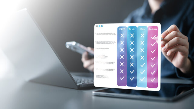 pricing, table, compare, plans, monthly, annual, tiers, Hand using tablet with digital pricing table interface comparing plans, tiers, features, and subscription options for online business services.