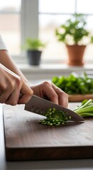 Close-up of hands chopping fresh green onions on a wooden cutting board in a bright kitchen setting.