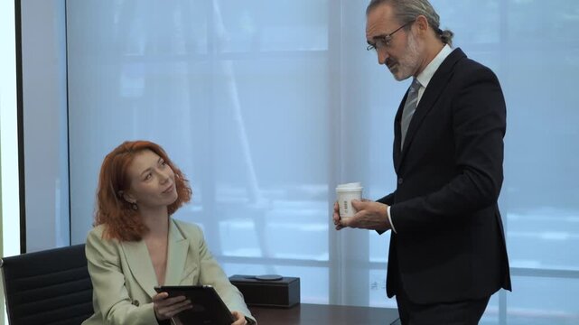 professional engaged in collaborative discussion in modern office. present idea use lablet while other active participate with gesture, seated comfortably around small table and contemporary decor