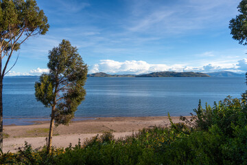 Lush green landscape overlooking Lake Titicaca from Llachon, Peru