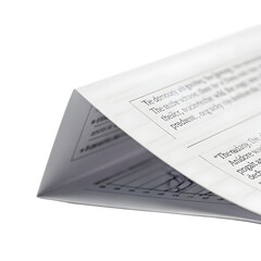 Folded paper pages with printed text and graphic elements against transparent background