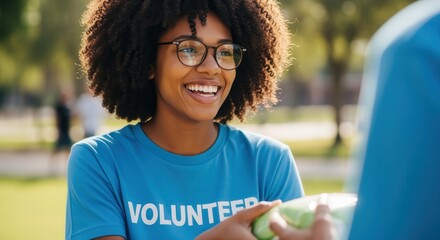 Smiling black female volunteer with afro hair and glasses at an outdoor community event.