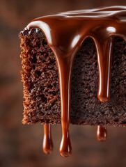 Close-up of a rich chocolate cake slice with glossy dripping icing. Decadent and indulgent dessert concept with warm tones and texture.
