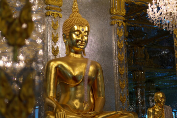 Side view of Golden Buddha in Glass Ubosot at Wat phuttha prommayan, Chachoengsao Province Thailand