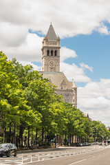 The historic Old Post Office Tower stands tall behind a green canopy on Pennsylvania Avenue.