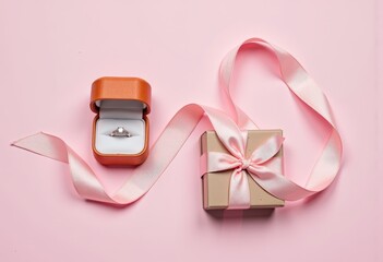 Elegant diamond ring in a luxurious orange box with a pink gift box featuring a satin ribbon on a pastel pink background, symbolizing love and celebration