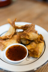 Crispy fried dumpling paste stuffed chop pork served with dipping sweet chili sauce, popular appetizer
