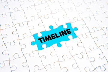 Word &ldquo;TIMELINE&rdquo; revealed through missing puzzle piece on blue background, symbolizing project planning, scheduling, process management, and business development concept.